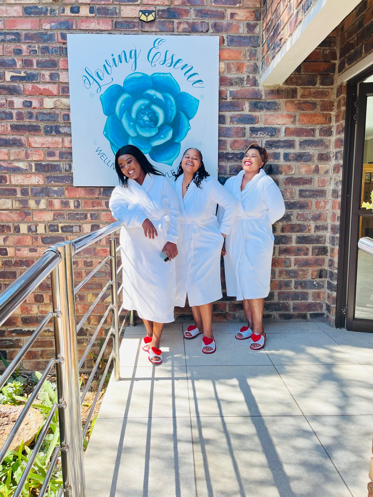 Guests standing under the Loving Essence Spa sign.